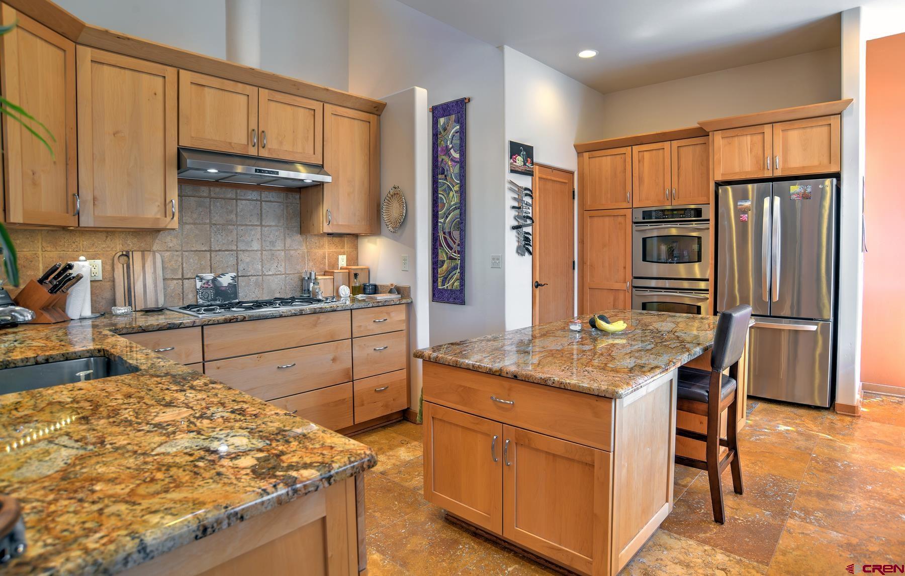 95 Puma Place Durango, CO 81301 - Photo 12 of 45 a kitchen with stainless steel appliances granite countertop a sink stove and refrigerator
