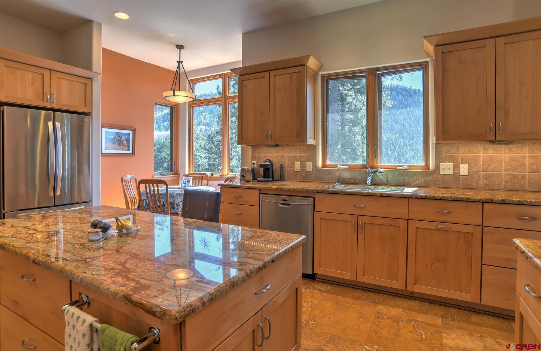 95 Puma Place Durango, CO 81301 - Photo 14 of 45 a kitchen with stainless steel appliances granite countertop a sink a stove and a wooden cabinets