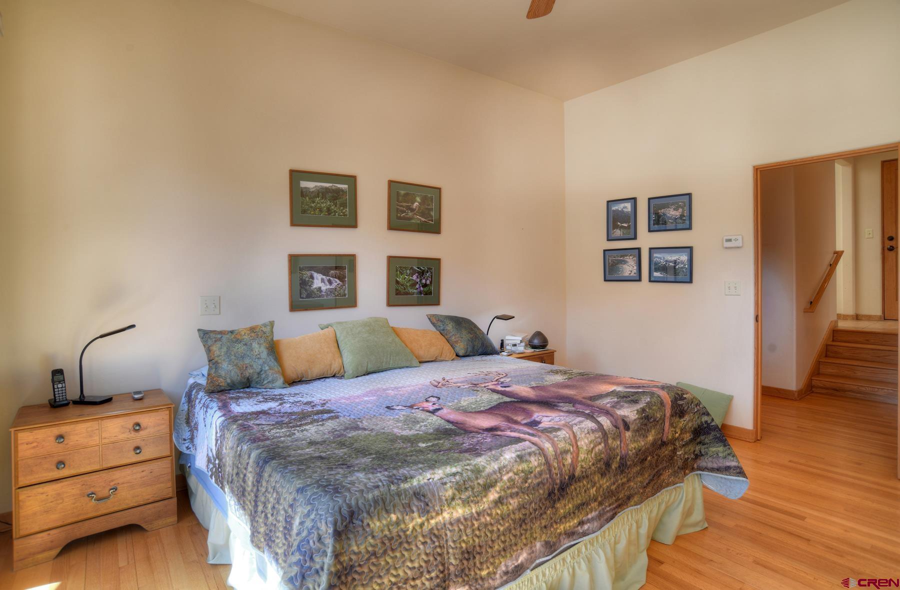 95 Puma Place Durango, CO 81301 - Photo 15 of 45 a bedroom with a bed and wooden floor