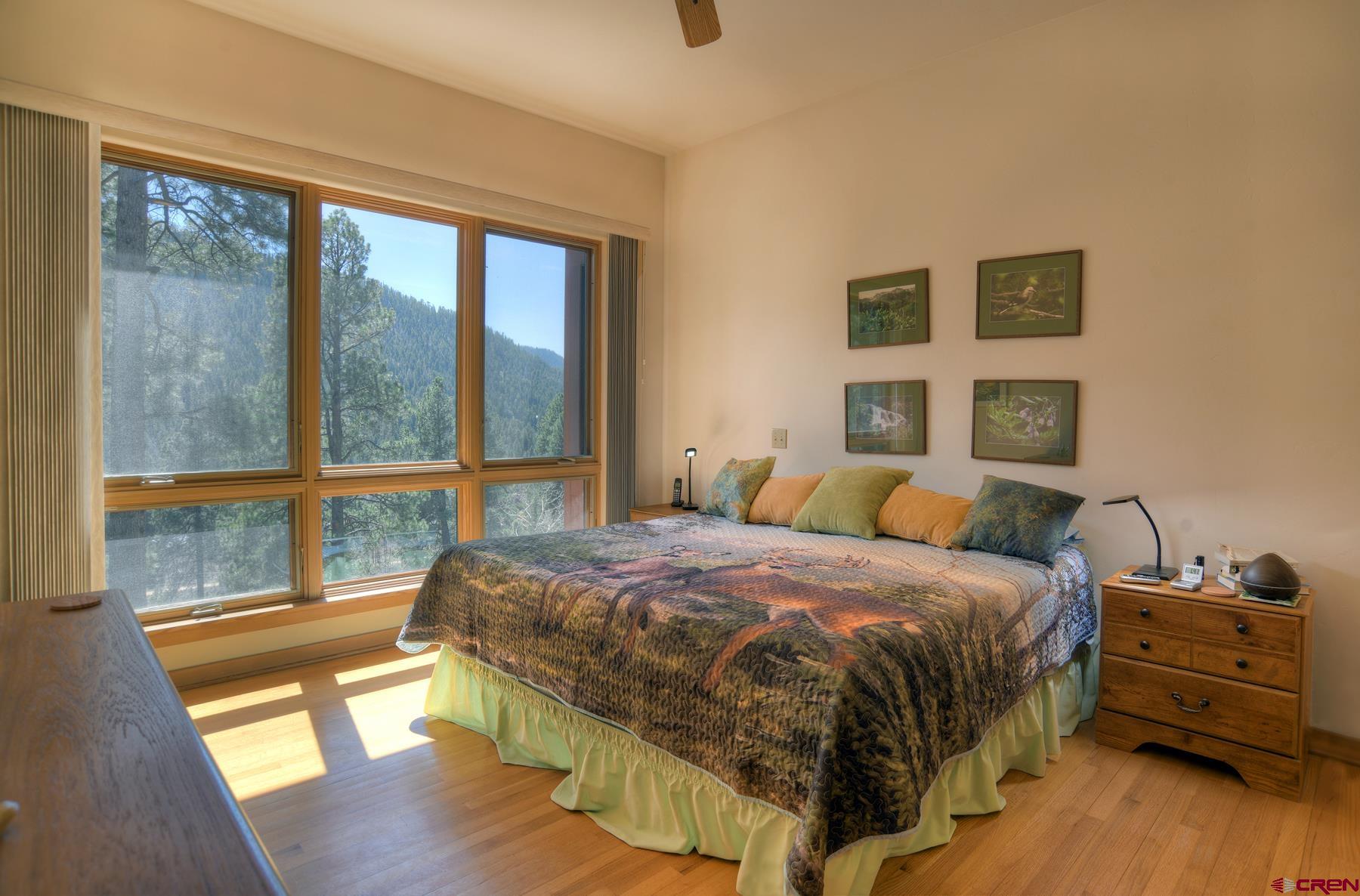 95 Puma Place Durango, CO 81301 - Photo 16 of 45 a bedroom with a bed and wooden floor
