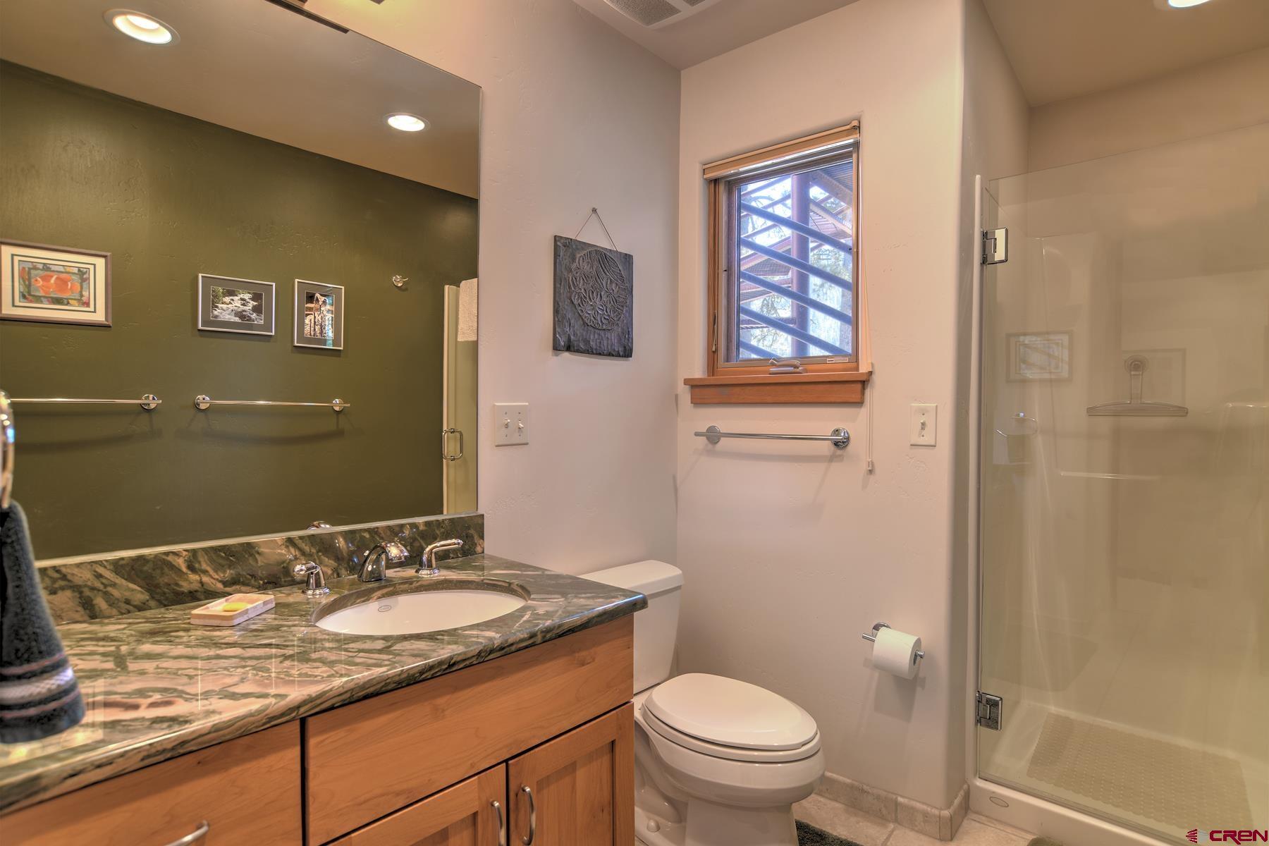 95 Puma Place Durango, CO 81301 - Photo 30 of 45 a bathroom with a granite countertop sink toilet and a mirror