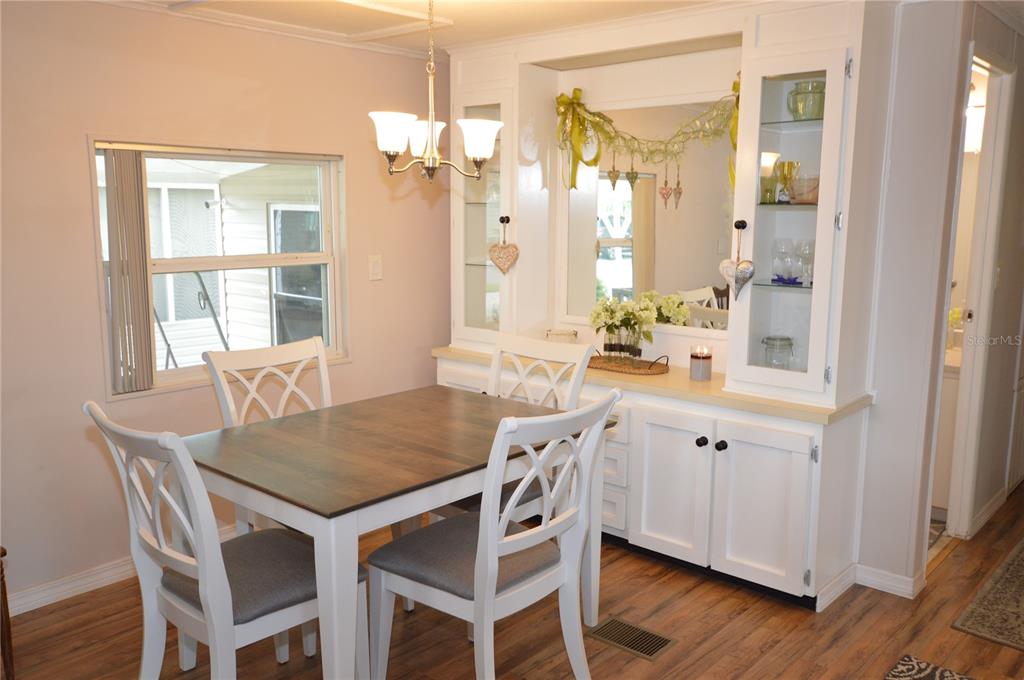 140 Rarotonga Road North Port, FL 34287 - Photo 11 of 42 a view of a dining room with furniture and wooden floor