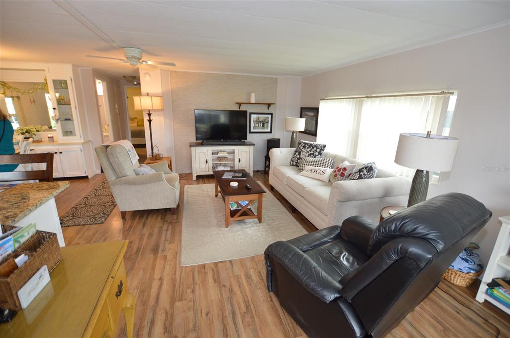 140 Rarotonga Road North Port, FL 34287 - Photo 12 of 42 a living room with furniture and a flat screen tv