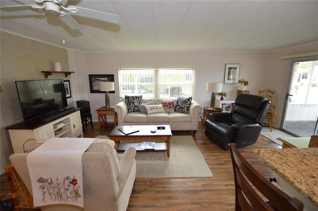 140 Rarotonga Road North Port, FL 34287 - Photo 13 of 42 a living room with furniture and a flat screen tv