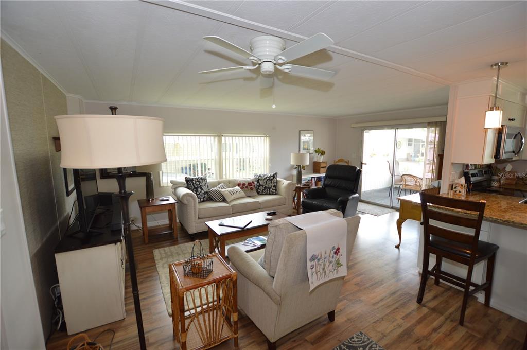 140 Rarotonga Road North Port, FL 34287 - Photo 14 of 42 a living room with furniture a large window and a table