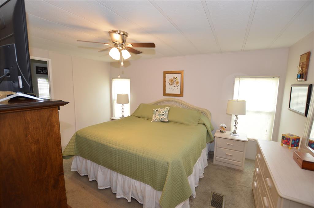140 Rarotonga Road North Port, FL 34287 - Photo 15 of 42 a bedroom with a bed and a chandelier