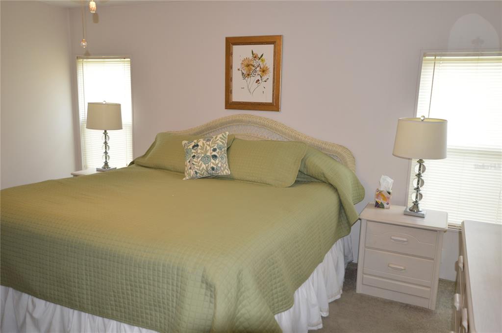 140 Rarotonga Road North Port, FL 34287 - Photo 16 of 42 a bedroom with a bed and a night stand
