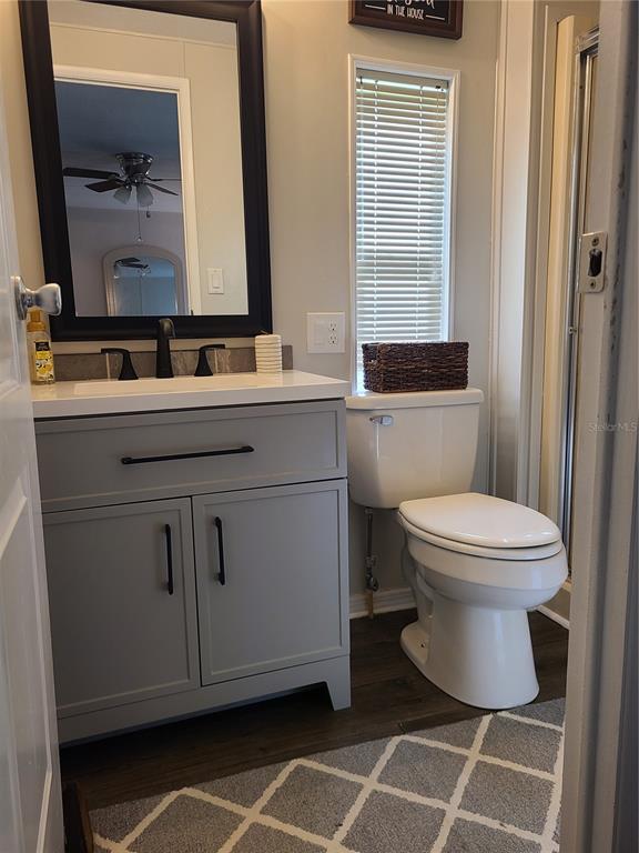 140 Rarotonga Road North Port, FL 34287 - Photo 18 of 42 a bathroom with a toilet a sink and a mirror