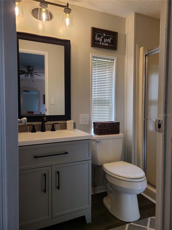 140 Rarotonga Road North Port, FL 34287 - Photo 19 of 42 a bathroom with a toilet a sink and mirror