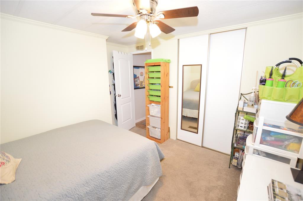 140 Rarotonga Road North Port, FL 34287 - Photo 21 of 42 a bedroom with a bed and a chandelier