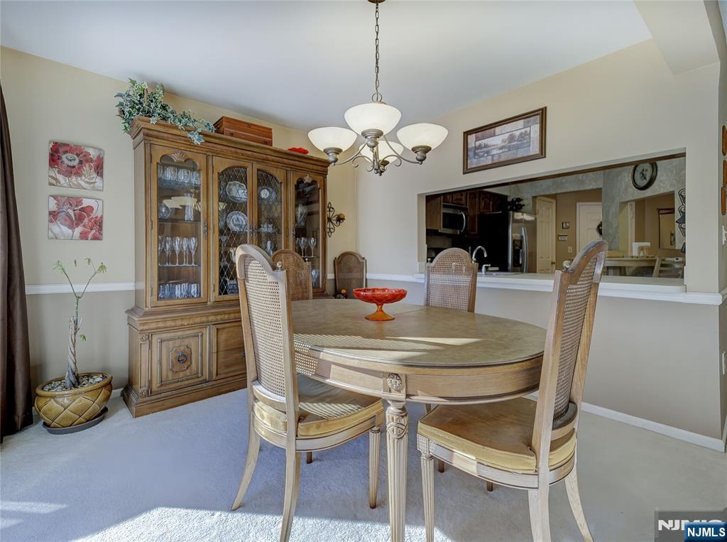 101 Quartz Lane Paterson, NJ 07501 - Photo 14 of 34 a dining room with wooden floor and chandelier