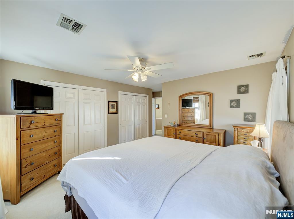 101 Quartz Lane Paterson, NJ 07501 - Photo 19 of 34 a bedroom with a bed and wooden floor