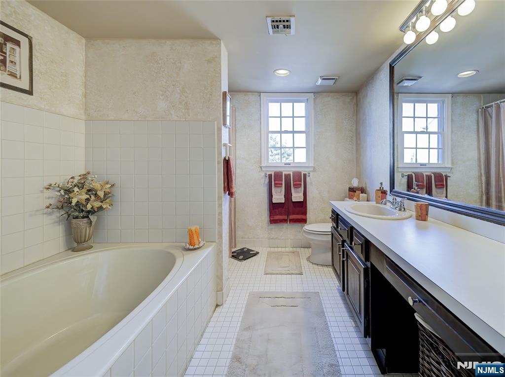101 Quartz Lane Paterson, NJ 07501 - Photo 21 of 34 a bathroom with a tub sink double vanity granite and tub