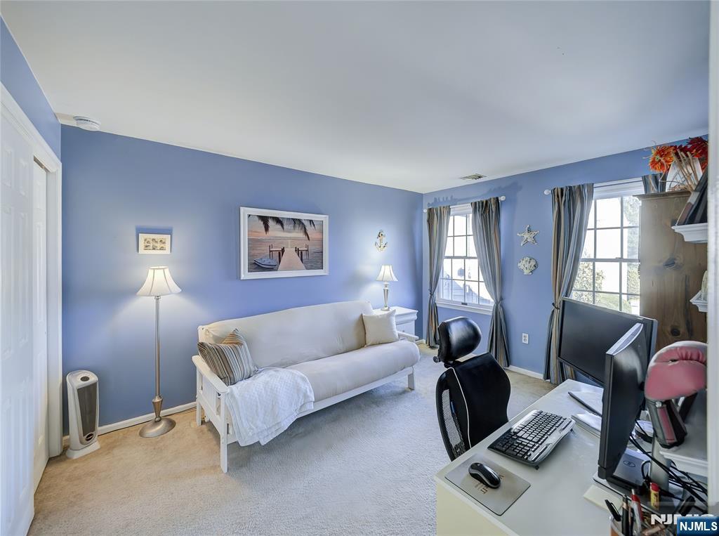 101 Quartz Lane Paterson, NJ 07501 - Photo 22 of 34 a living room with furniture a window and a flat screen tv