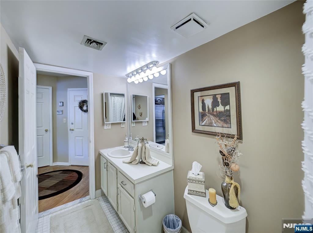 101 Quartz Lane Paterson, NJ 07501 - Photo 26 of 34 a bathroom with a sink a vanity and a mirror