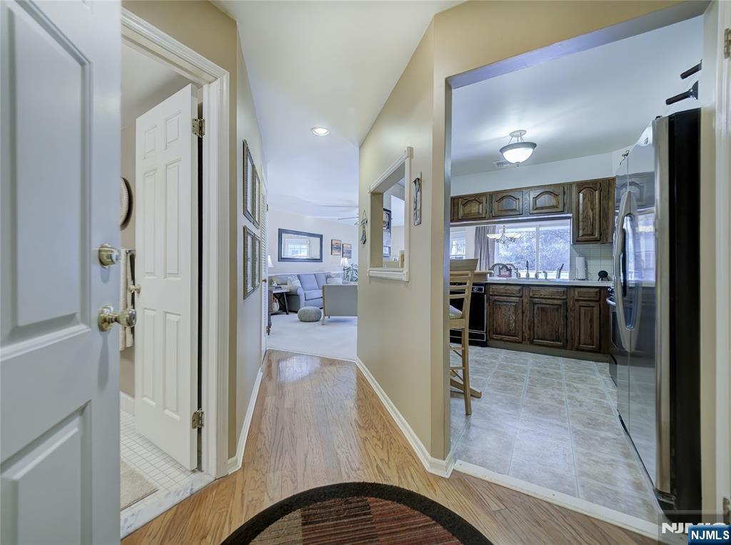 101 Quartz Lane Paterson, NJ 07501 - Photo 7 of 34 a kitchen with stainless steel appliances a refrigerator and a wooden floor