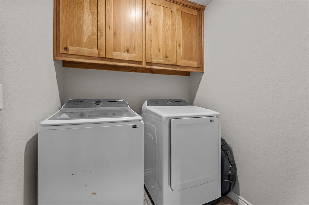 509 Pecan Tree Court Poolville, TX 76487 - Photo 11 of 25 a utility room with dryer and washer