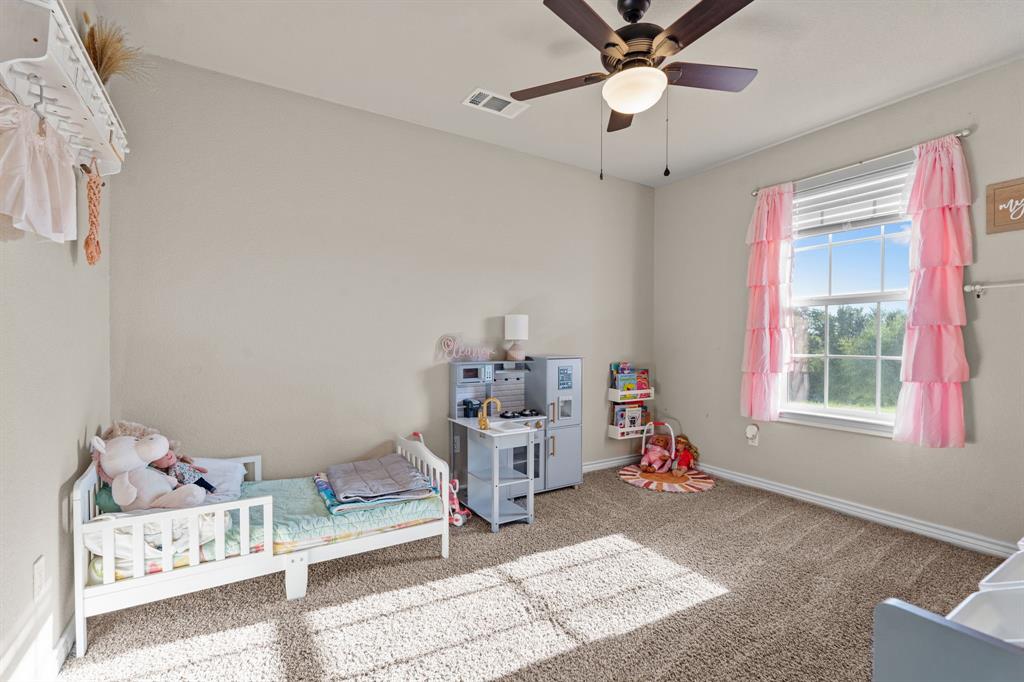 509 Pecan Tree Court Poolville, TX 76487 - Photo 12 of 25 a very nice looking room with a hanging light kitchen