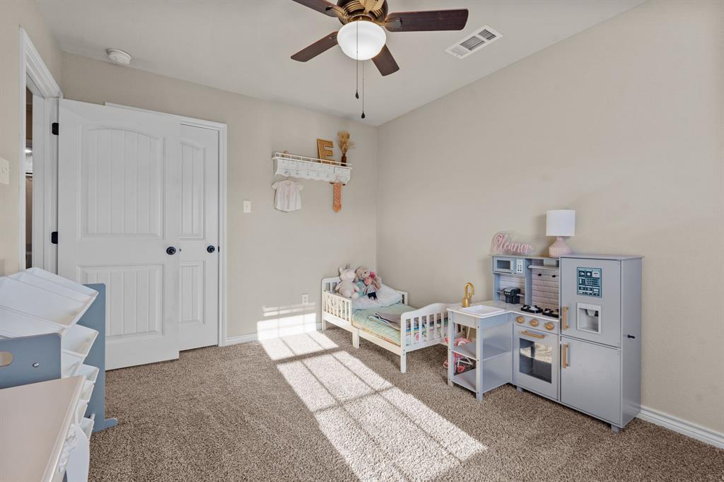 509 Pecan Tree Court Poolville, TX 76487 - Photo 13 of 25 a living room with furniture and a chandelier fan