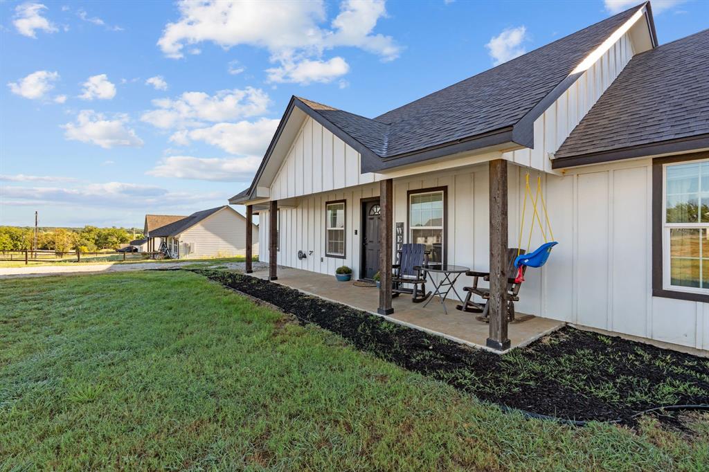 509 Pecan Tree Court Poolville, TX 76487 - Photo 22 of 25 a view of a house with backyard sitting area and garden