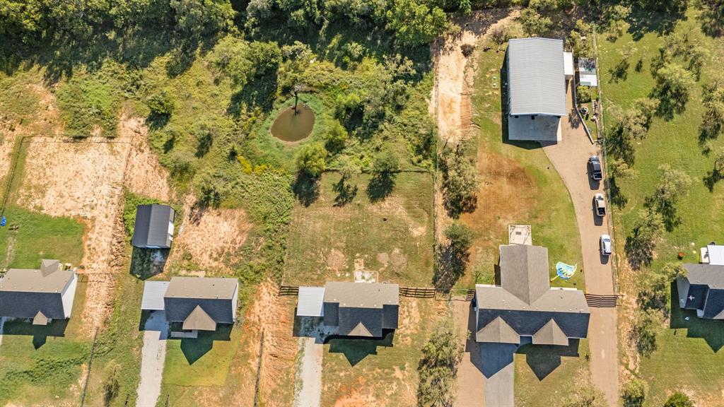 509 Pecan Tree Court Poolville, TX 76487 - Photo 25 of 25 an aerial view of residential houses with outdoor space