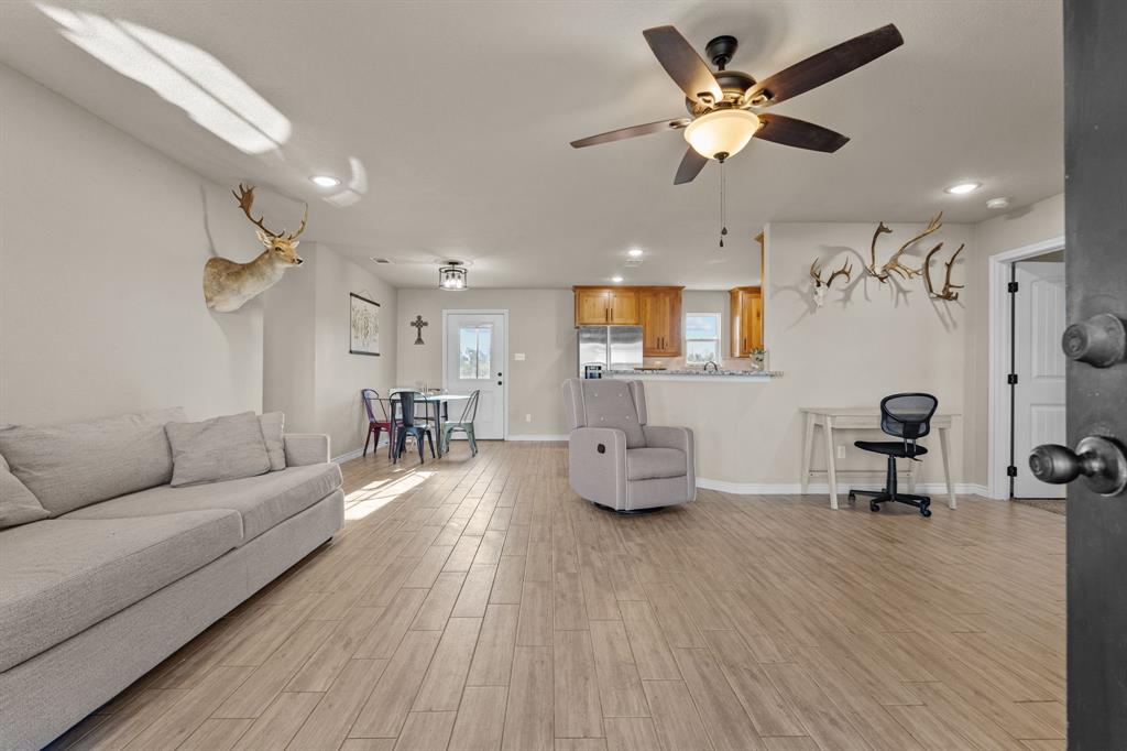 509 Pecan Tree Court Poolville, TX 76487 - Photo 3 of 25 a living room with furniture and a wooden floor