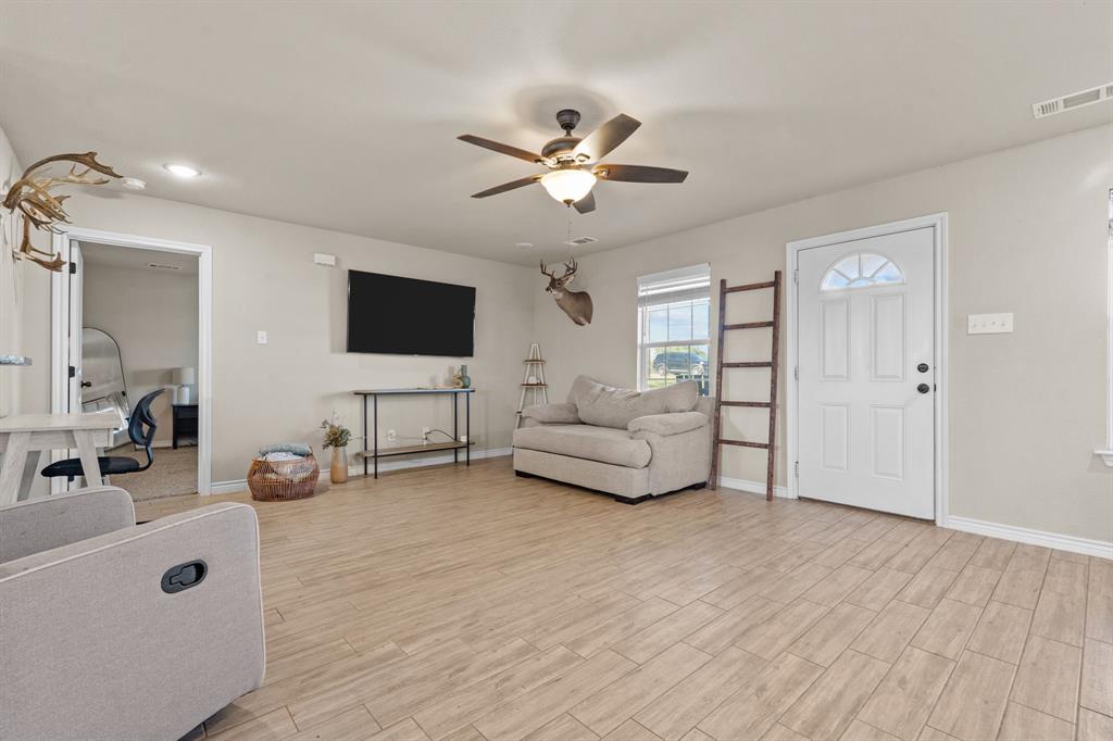 509 Pecan Tree Court Poolville, TX 76487 - Photo 5 of 25 a living room with furniture and a flat screen tv