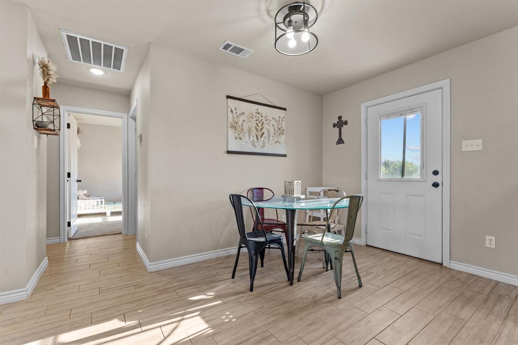 509 Pecan Tree Court Poolville, TX 76487 - Photo 6 of 25 a view of a dining room with furniture and wooden floor