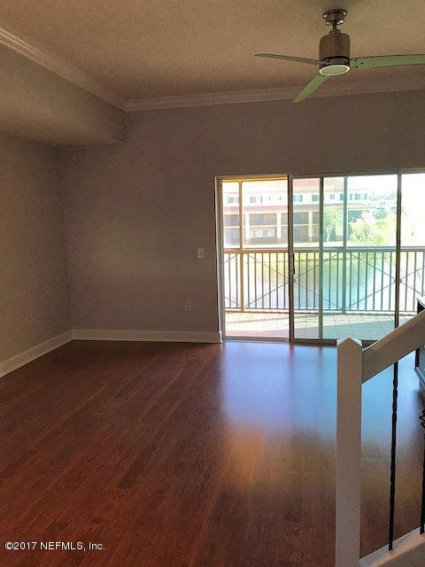 9745 Touchton Road, Unit 1828 Jacksonville, FL 32246 - Photo 8 of 26 a view of empty room with wooden floor and fan