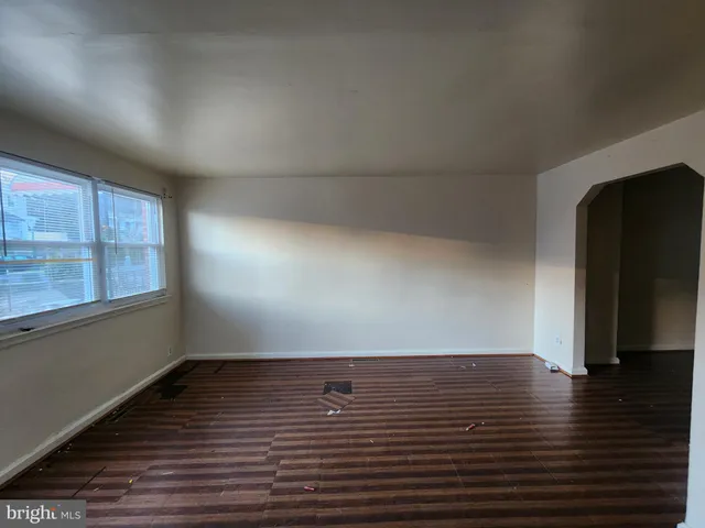 a view of room with window and wooden floor