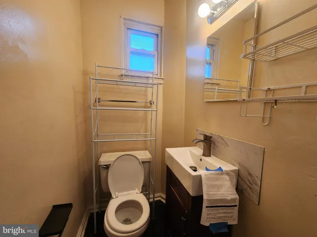 a bathroom with a sink mirror and toilet
