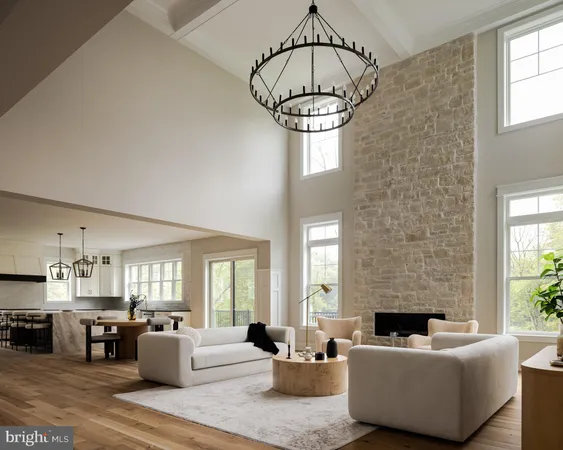 a living room with furniture a chandelier a fireplace and windows