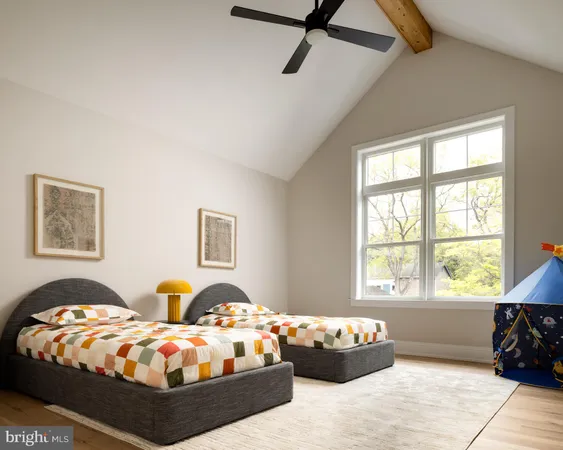 a bedroom with bed couch and window