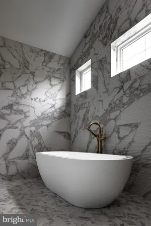 a white tub sitting next to a window