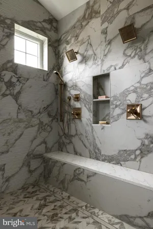 a bathroom with a granite countertop sink and a window