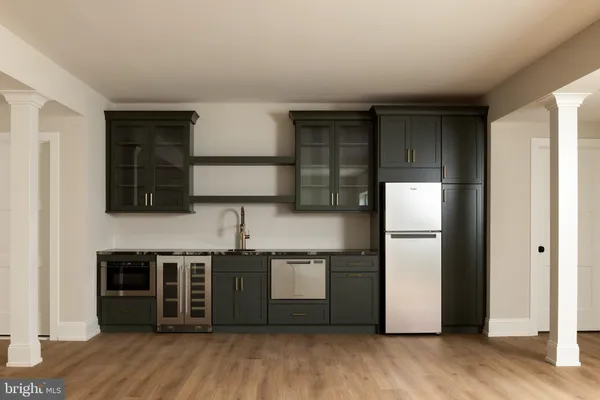 a kitchen with stainless steel appliances a refrigerator and a stove top oven