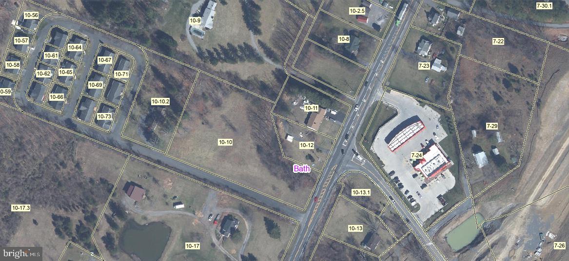 2218 Valley Road Berkeley Springs, WV 25411 - Photo 2 of 32 a multi story building with lots of trees