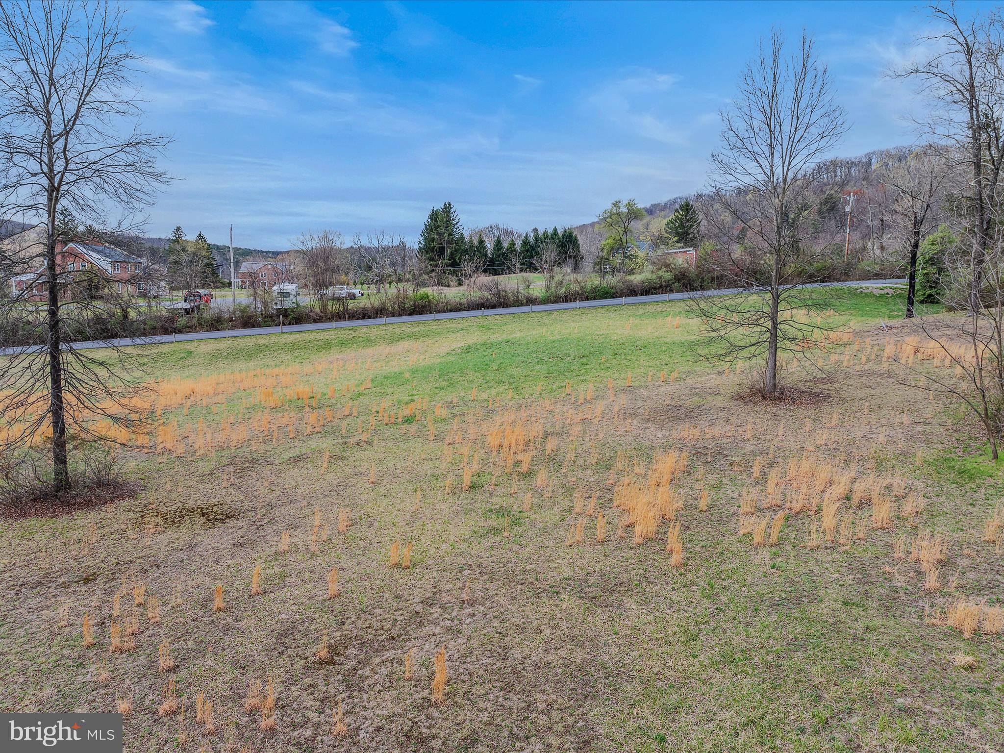 2218 Valley Road Berkeley Springs, WV 25411 - Photo 7 of 32 a view of a field with trees in the background