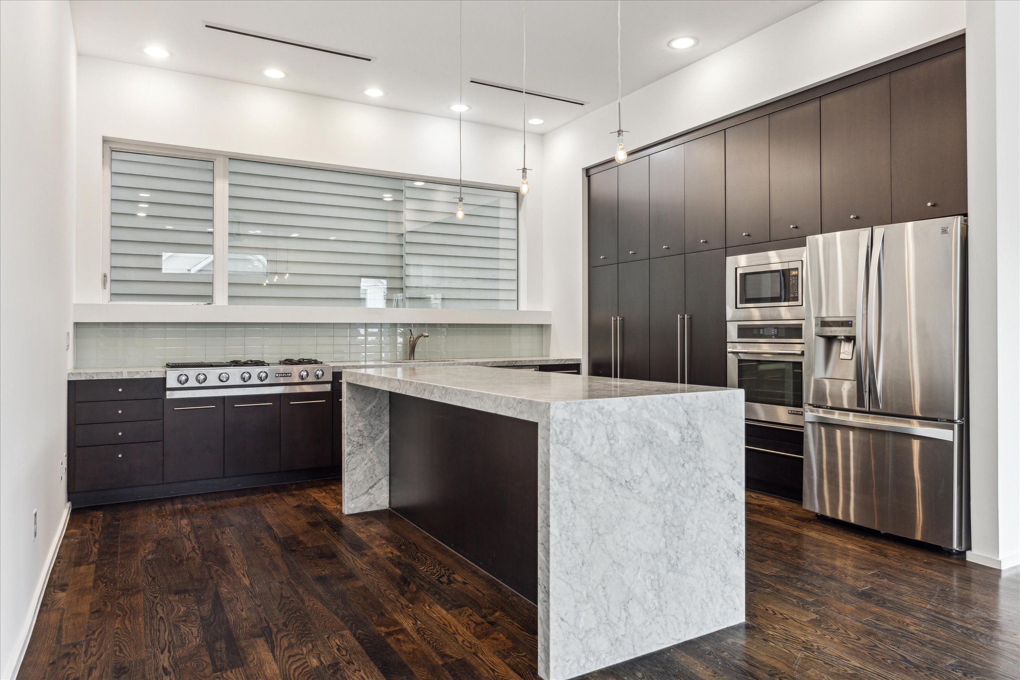 1728 Michigan Street, Unit A Houston, TX 77006 - Photo 13 of 38 a kitchen with stainless steel appliances kitchen island granite countertop a stove and a refrigerator