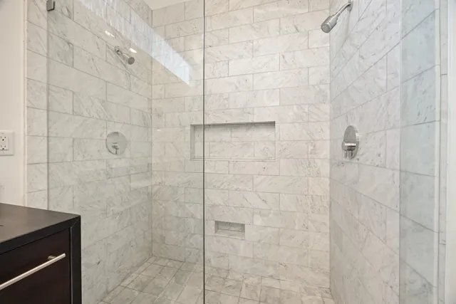 a view of an empty room with wooden floor and entryway