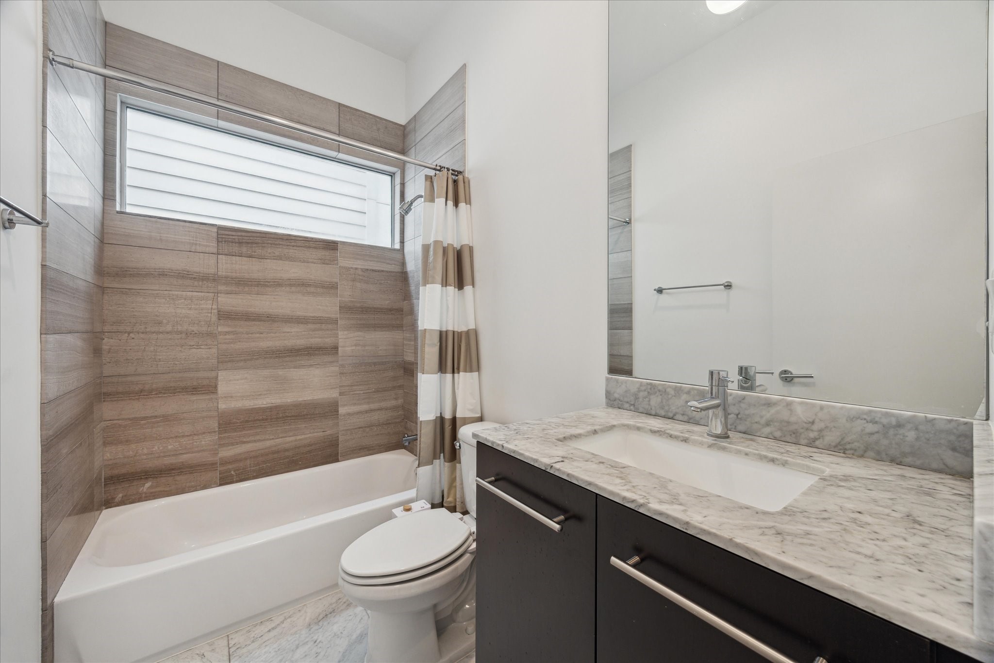 1728 Michigan Street, Unit A Houston, TX 77006 - Photo 24 of 38 a bathroom with a granite countertop sink a toilet and bathtub