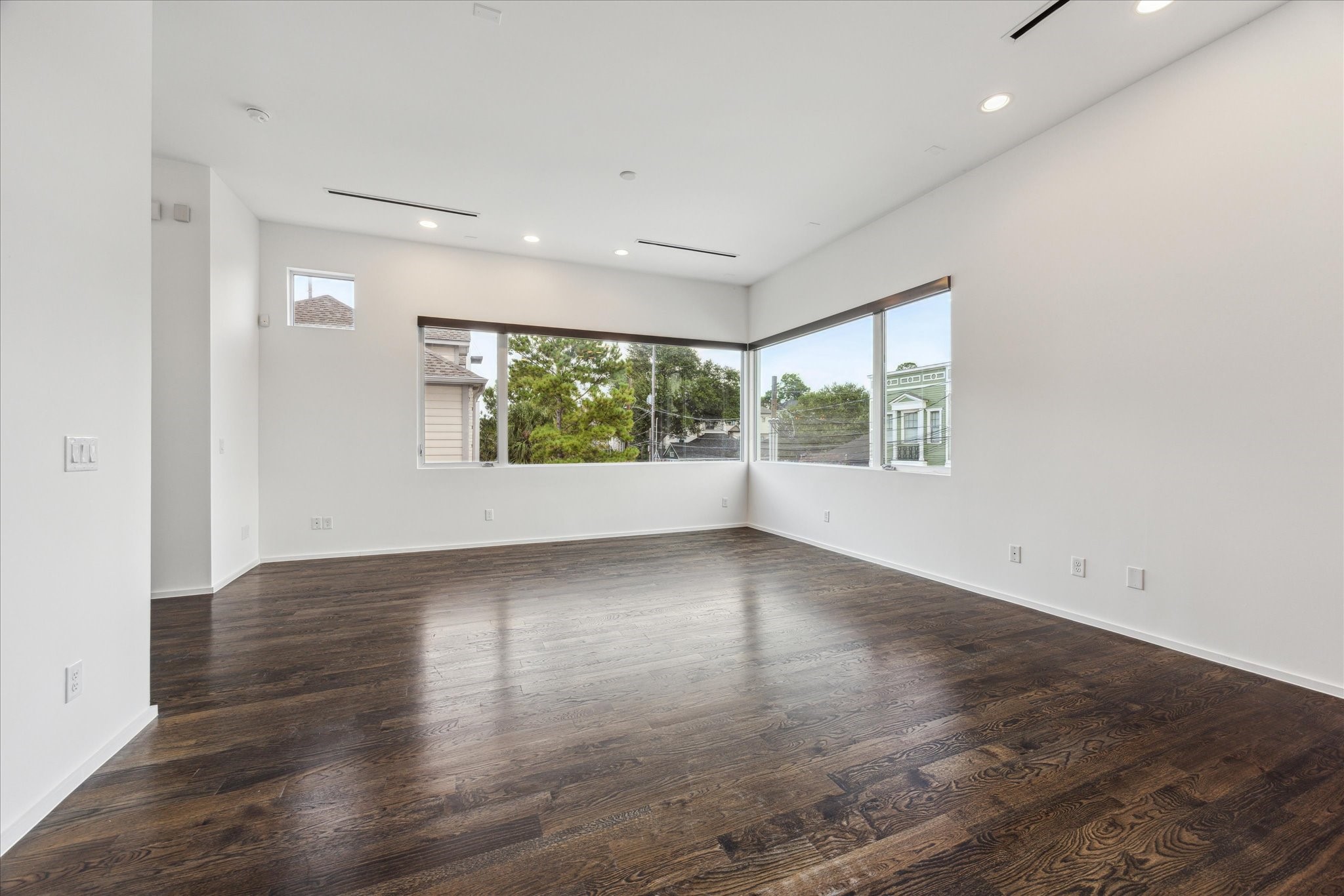 1728 Michigan Street, Unit A Houston, TX 77006 - Photo 7 of 38 an empty room with wooden floor and windows