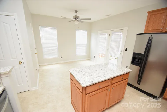 a kitchen with stainless steel appliances granite countertop a refrigerator and a sink