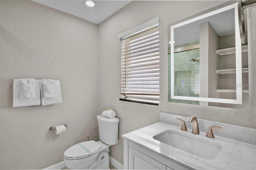 5830 Midnight Pass Road, Unit 107 Sarasota, FL 34242 - Photo 14 of 18 a bathroom with a sink and a toilet