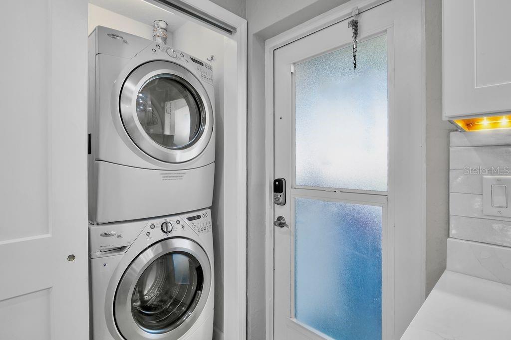 5830 Midnight Pass Road, Unit 107 Sarasota, FL 34242 - Photo 17 of 18 a view of a hallway with washer and dryer