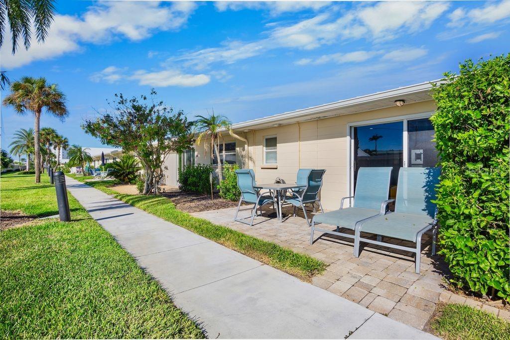 5830 Midnight Pass Road, Unit 107 Sarasota, FL 34242 - Photo 2 of 18 a view of a backyard with sitting area and garden