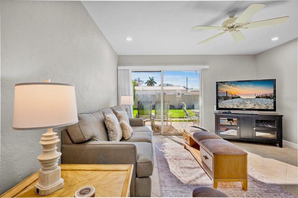 5830 Midnight Pass Road, Unit 107 Sarasota, FL 34242 - Photo 7 of 18 a living room with furniture and a flat screen tv
