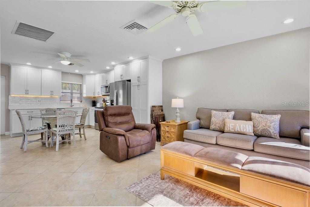 5830 Midnight Pass Road, Unit 107 Sarasota, FL 34242 - Photo 9 of 18 a living room with furniture and a chandelier