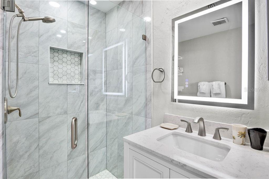 5830 Midnight Pass Road, Unit 107 Sarasota, FL 34242 - Photo 10 of 18 a bathroom with a sink and a mirror