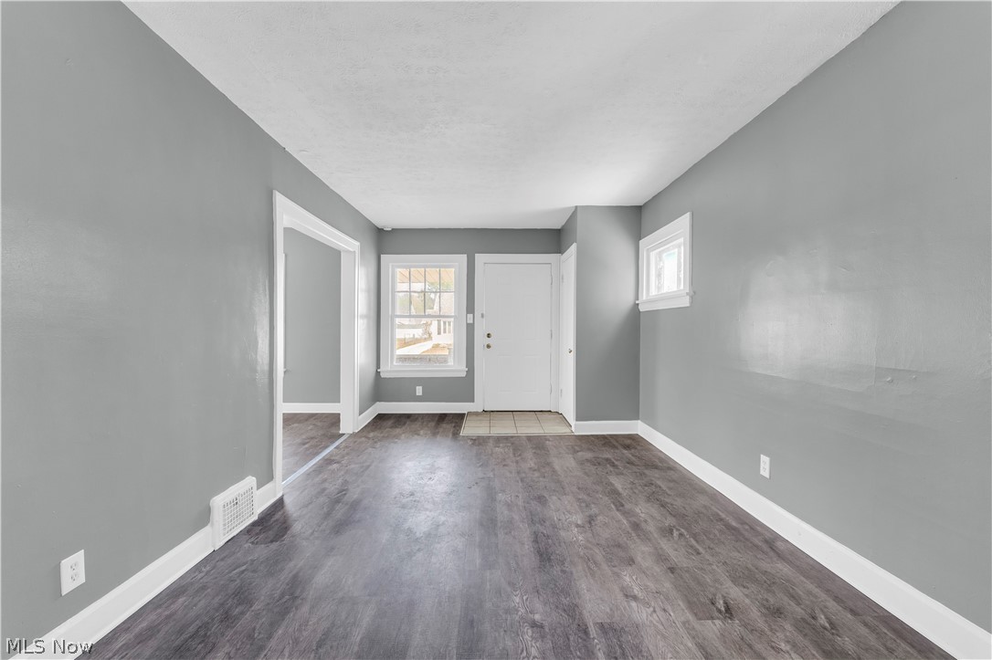 12808 Havana Road Cleveland, OH 44125 - Photo 5 of 19 Spacious interior room with wood-finish flooring, light gray walls, and white trim
